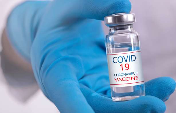 Entwicklung und Erstellung eines Coronavirus-Impfstoffs Ein Arzt hält einen COVID-19 Impfstoff in der Hand